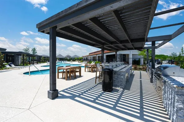a view of a patio with a table chairs and a floor to ceiling window