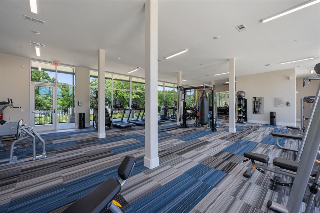 579 Lloyd's Road, Unit 820B Little Elm, TX 75068 - Photo 30 of 37 a room with lots of wooden furniture and windows