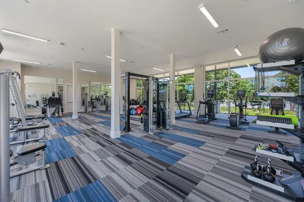 a room with lots of wooden furniture wooden floor and a rug