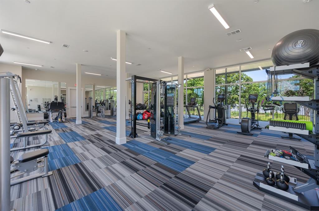 579 Lloyd's Road, Unit 820B Little Elm, TX 75068 - Photo 32 of 37 a room with lots of wooden furniture wooden floor and a rug