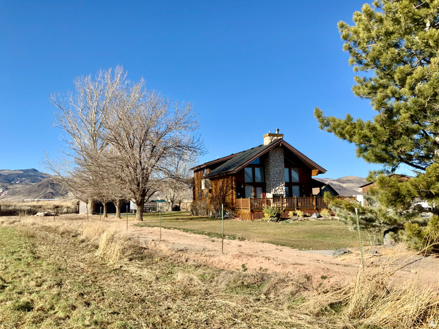 76 Highway 118 Monroe, UT 84754 - Photo 21 of 76 View of side of property with a wooden deck, a chimney, a lawn, and a view of rural / pastoral area