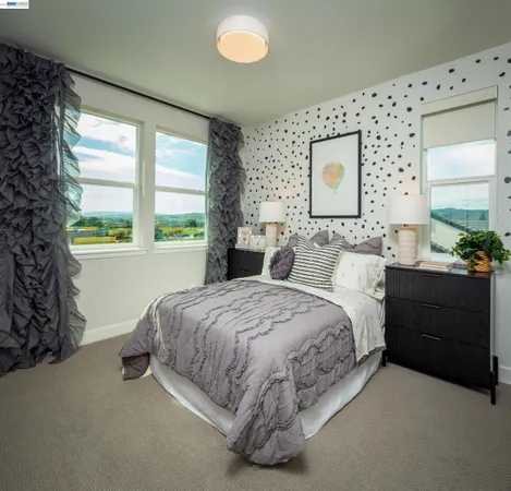 a spacious bedroom with a bed and a dresser