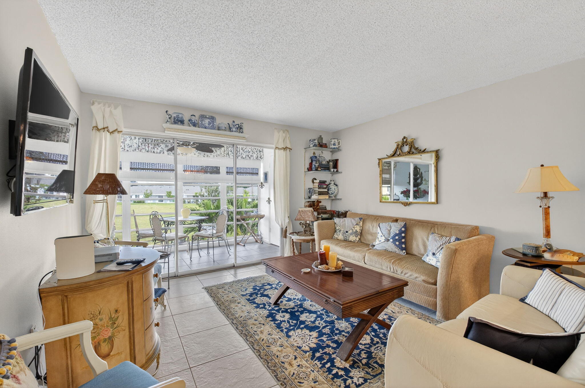 13757 Flora Place, Unit G Delray Beach, FL 33484 - Photo 11 of 58 a living room with furniture and a floor to ceiling window