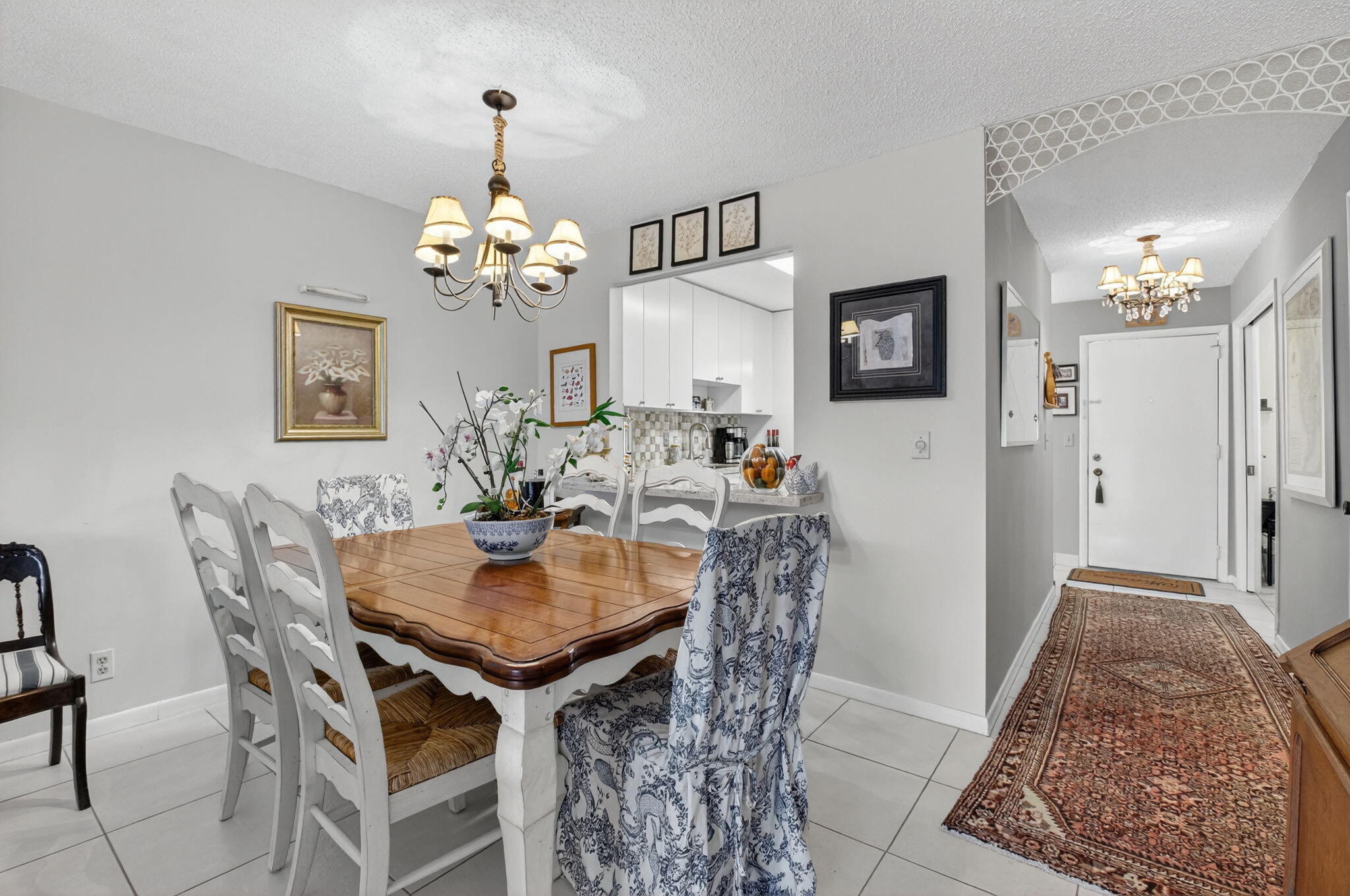 13757 Flora Place, Unit G Delray Beach, FL 33484 - Photo 13 of 58 a view of a dining room with furniture and chandelier