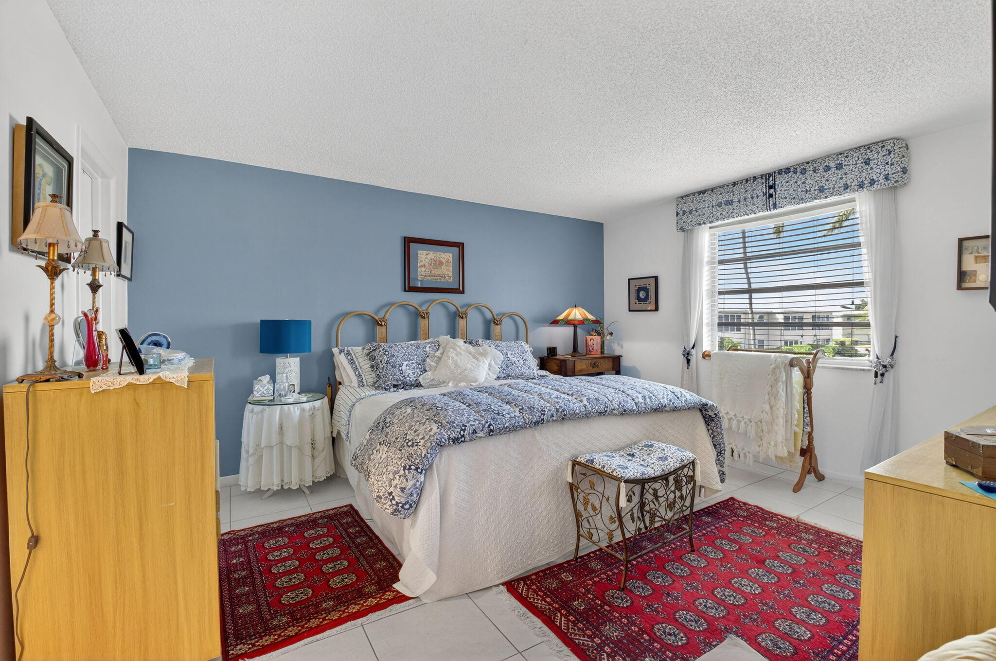 13757 Flora Place, Unit G Delray Beach, FL 33484 - Photo 14 of 58 a bedroom with a bed wooden floor and a window