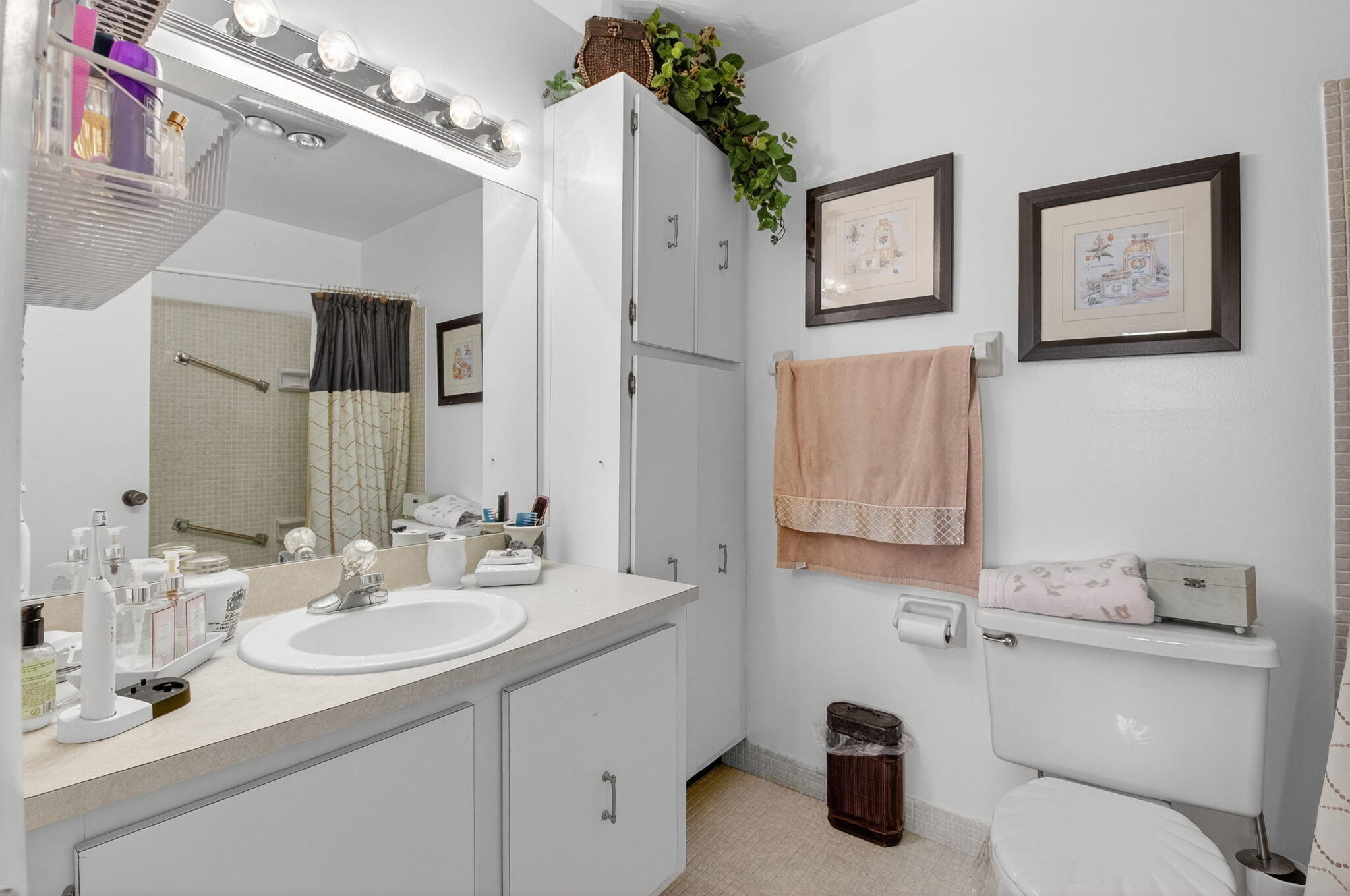 13757 Flora Place, Unit G Delray Beach, FL 33484 - Photo 16 of 58 a bathroom with a granite countertop sink a toilet and mirror