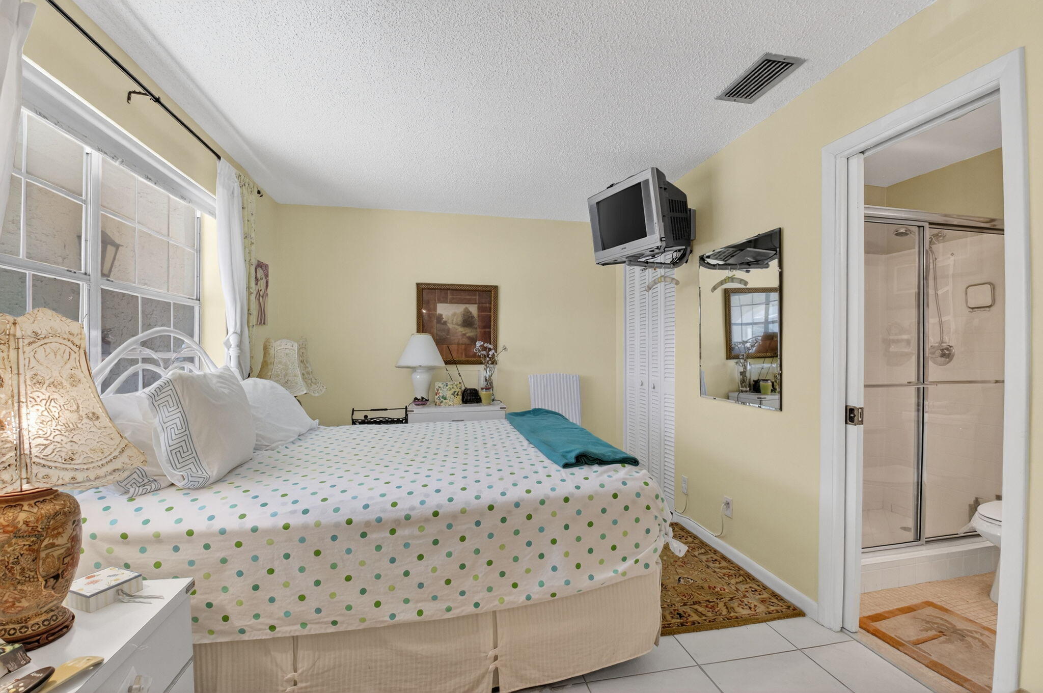 13757 Flora Place, Unit G Delray Beach, FL 33484 - Photo 18 of 58 a bedroom with a bed and wooden floor