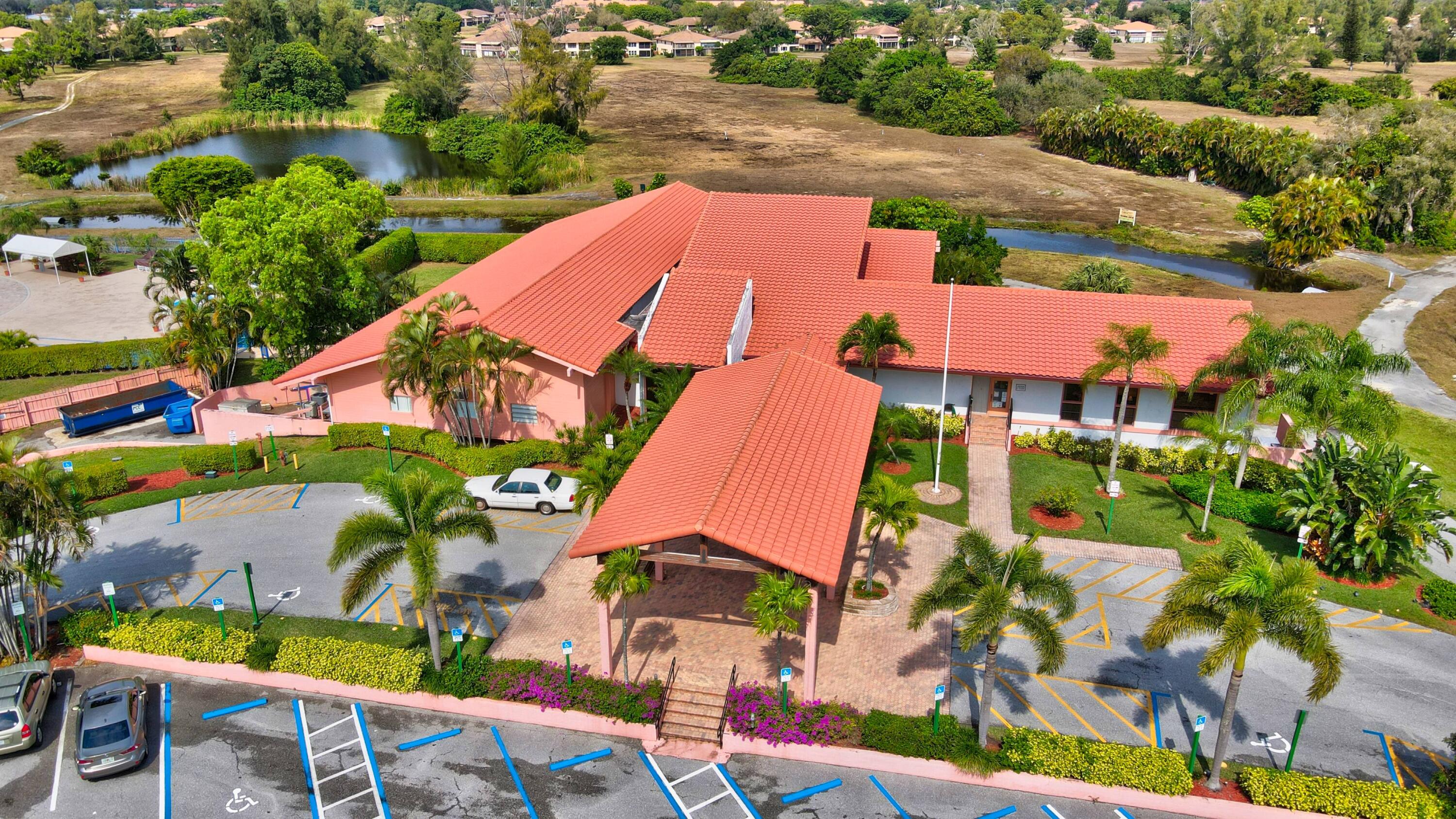 13757 Flora Place, Unit G Delray Beach, FL 33484 - Photo 27 of 58 an aerial view of houses with yard