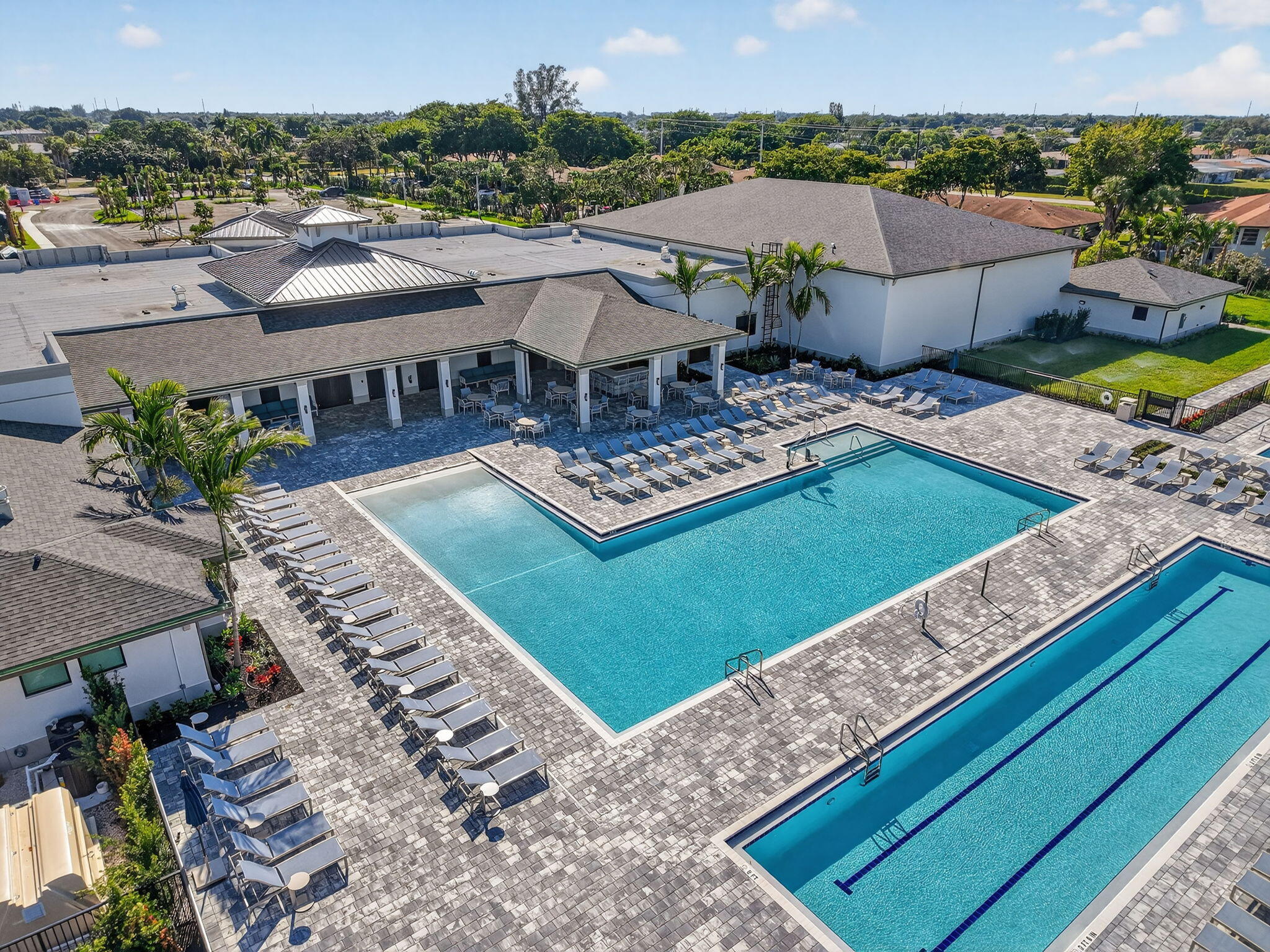 13757 Flora Place, Unit G Delray Beach, FL 33484 - Photo 53 of 58 a view of a house with pool and chairs