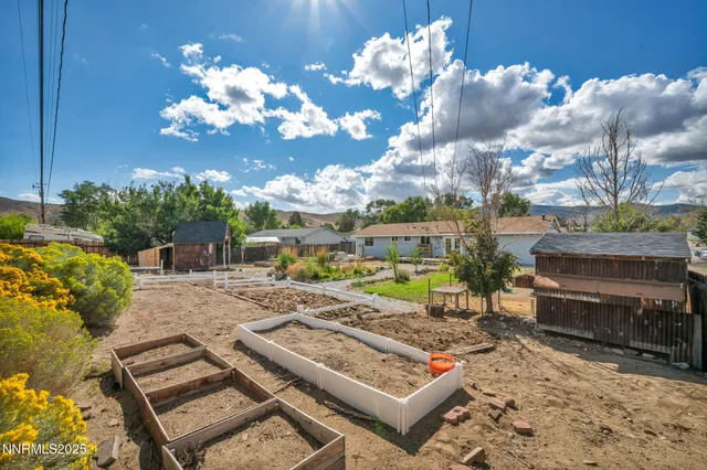 a view of a backyard with sitting area