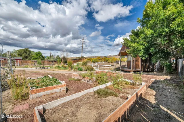 a view of a house with a backyard and a chair