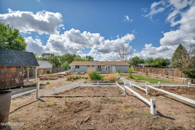 an aerial view of a house with a mountain