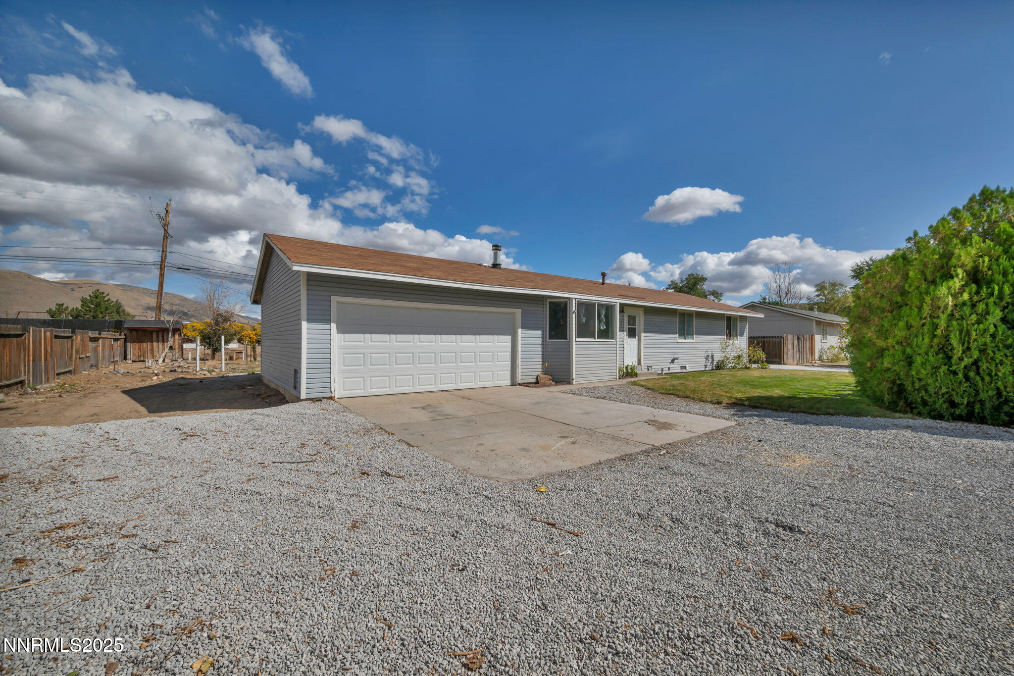 17475 Egret Lane Reno, NV 89508 - Photo 2 of 67 a front view of a house with a yard and garage