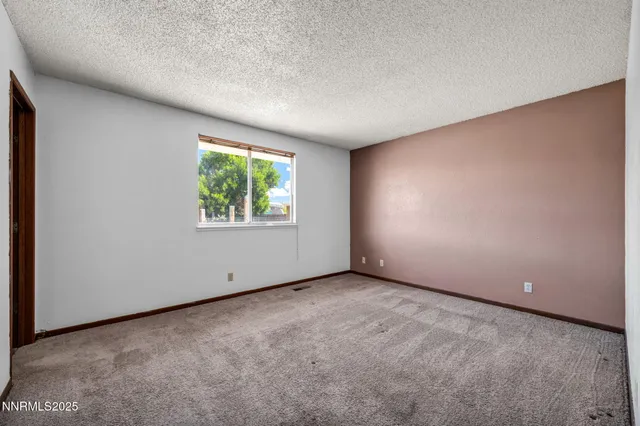 a kitchen with a refrigerator and wooden floor