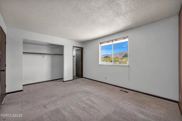 a view of a living room a refrigerator and a stove
