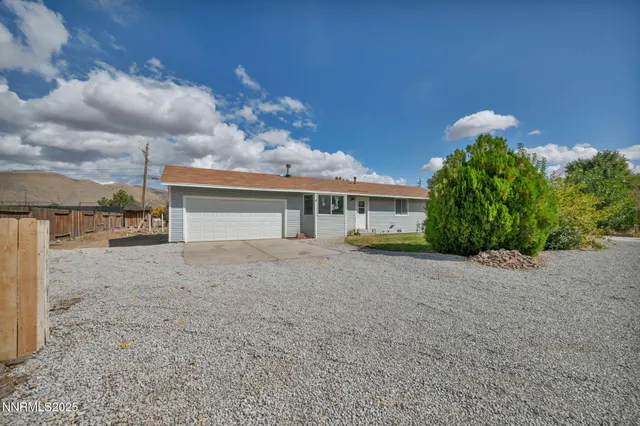 a view of a house with a yard and garage