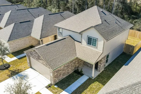 a aerial view of a house with a yard