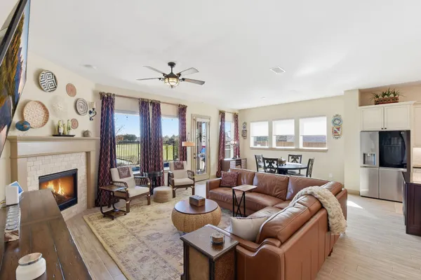 a living room with furniture a fireplace and a flat screen tv
