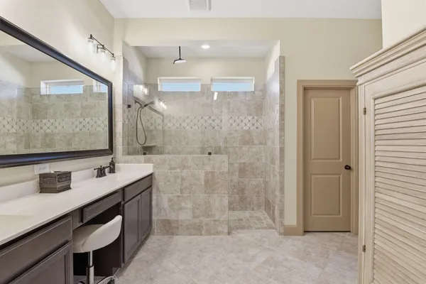 a bathroom with a sink double vanity and a mirror