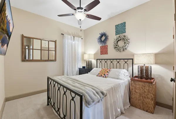 a bedroom with a bed and a chandelier