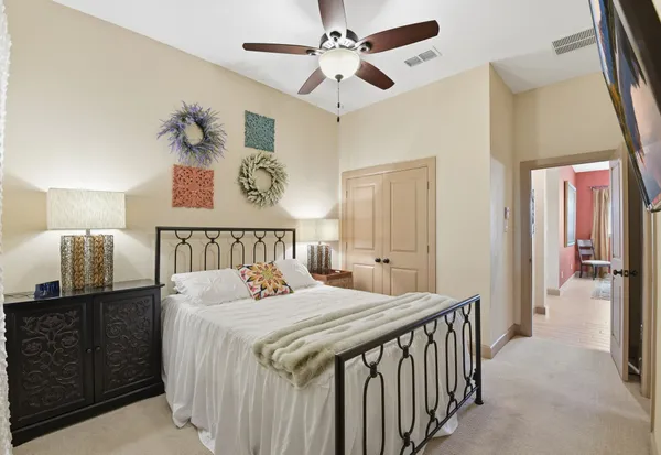a bedroom with a bed and a chandelier