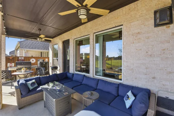 a living room with furniture and a floor to ceiling window
