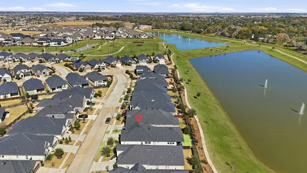 an aerial view of a city with a lake