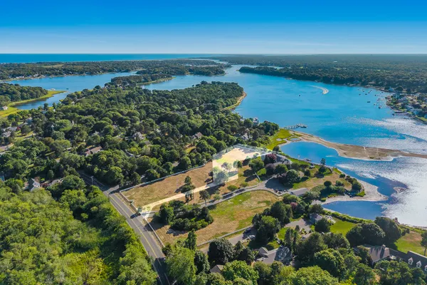 an aerial view of ocean with residential house