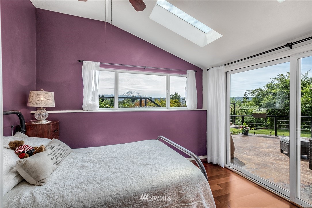 11112 Karshner Road East Edgewood, WA 98372 - Photo 11 of 40 a bedroom with a bed and large window
