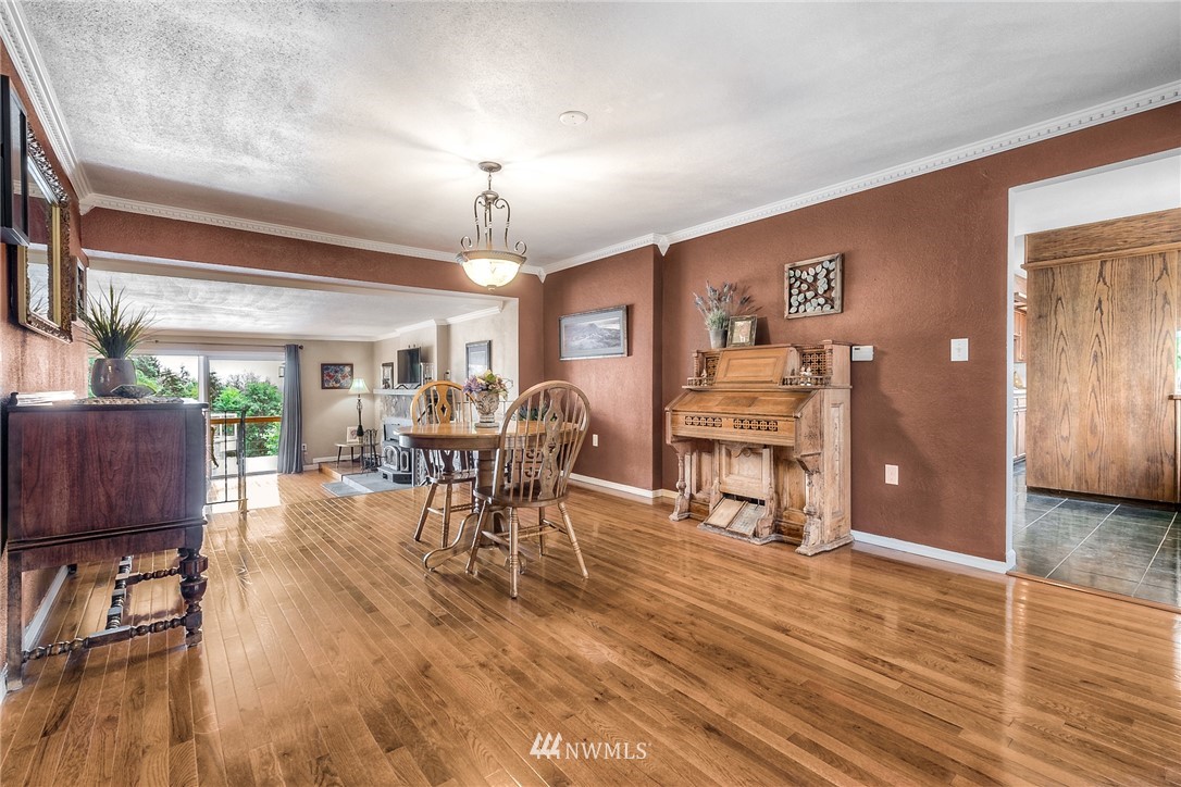 11112 Karshner Road East Edgewood, WA 98372 - Photo 13 of 40 a view of a dining room with furniture and wooden floor