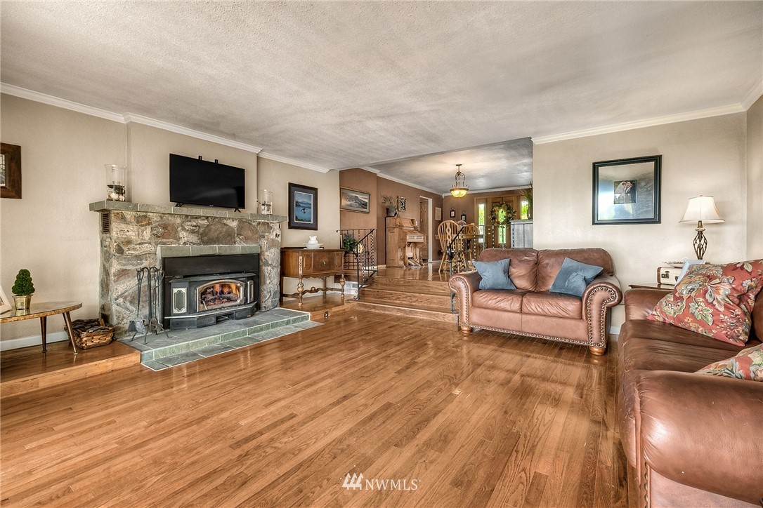 11112 Karshner Road East Edgewood, WA 98372 - Photo 14 of 40 a living room with furniture a flat screen tv and a fireplace