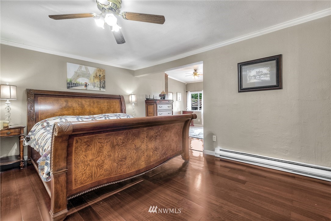 11112 Karshner Road East Edgewood, WA 98372 - Photo 17 of 40 a bedroom with a bed and a chandelier