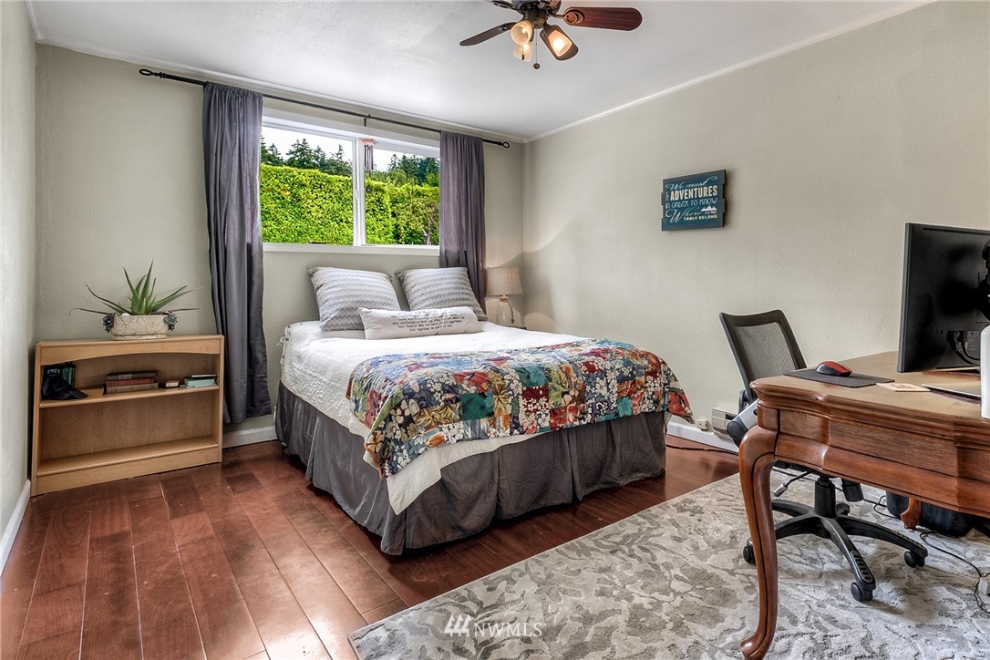 11112 Karshner Road East Edgewood, WA 98372 - Photo 21 of 40 a bedroom with a bed and a table in it