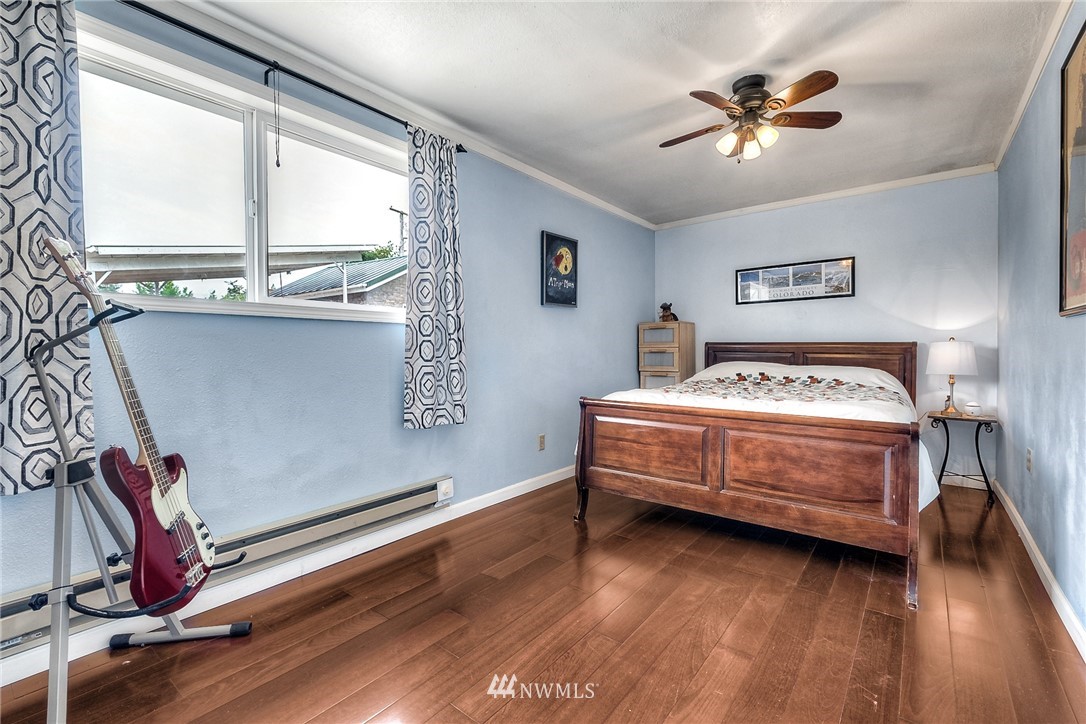 11112 Karshner Road East Edgewood, WA 98372 - Photo 22 of 40 a bedroom with a bed and a window