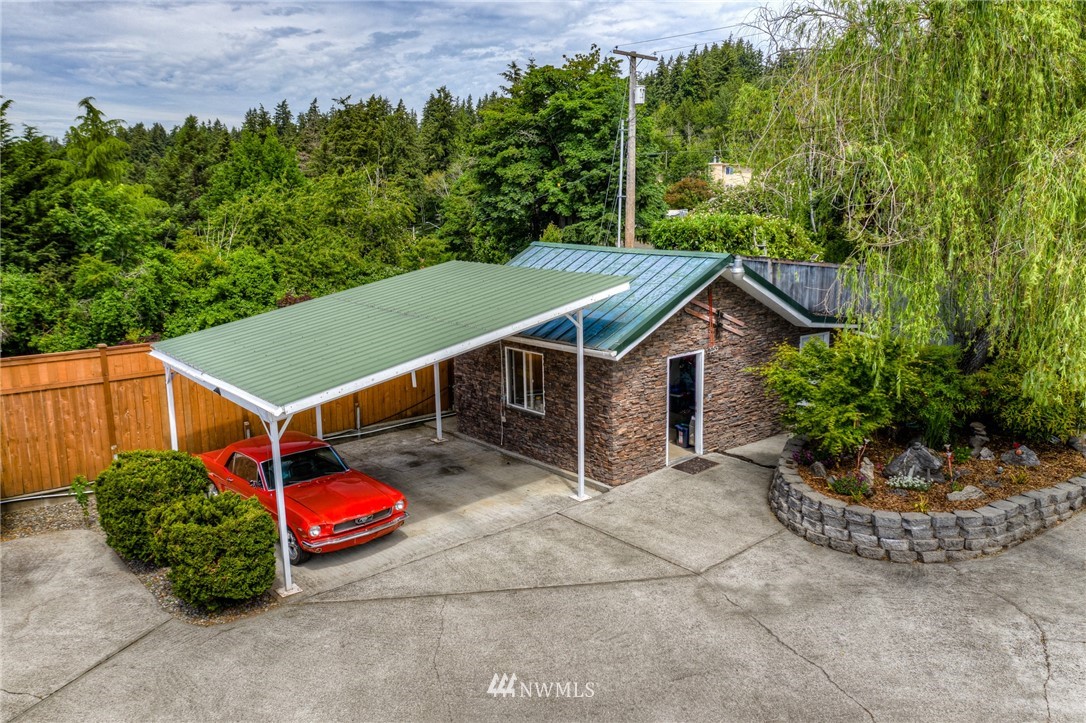 11112 Karshner Road East Edgewood, WA 98372 - Photo 25 of 40 a view of a house with a yard and potted plants