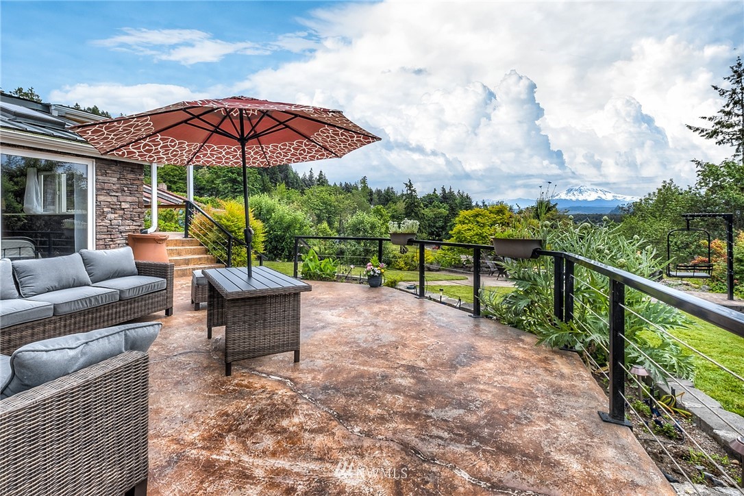 11112 Karshner Road East Edgewood, WA 98372 - Photo 32 of 40 a view of a two chairs with an umbrella in the balcony