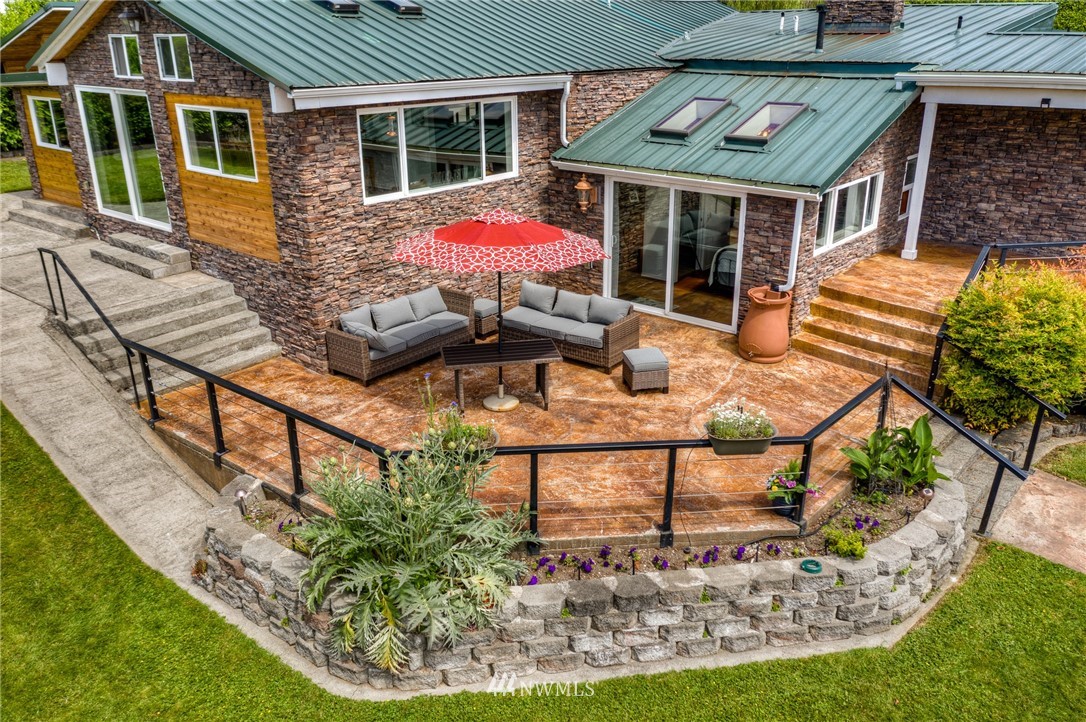11112 Karshner Road East Edgewood, WA 98372 - Photo 33 of 40 a view of a house with backyard porch and sitting area