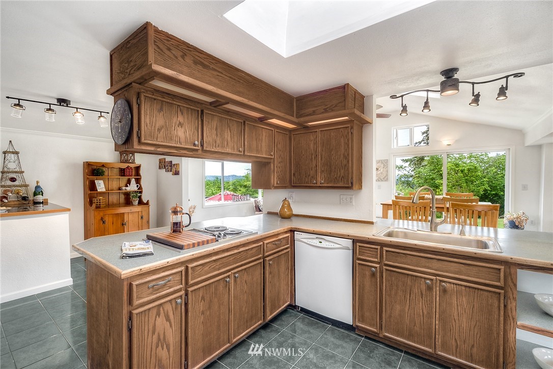11112 Karshner Road East Edgewood, WA 98372 - Photo 5 of 40 a kitchen that has a sink and a stove