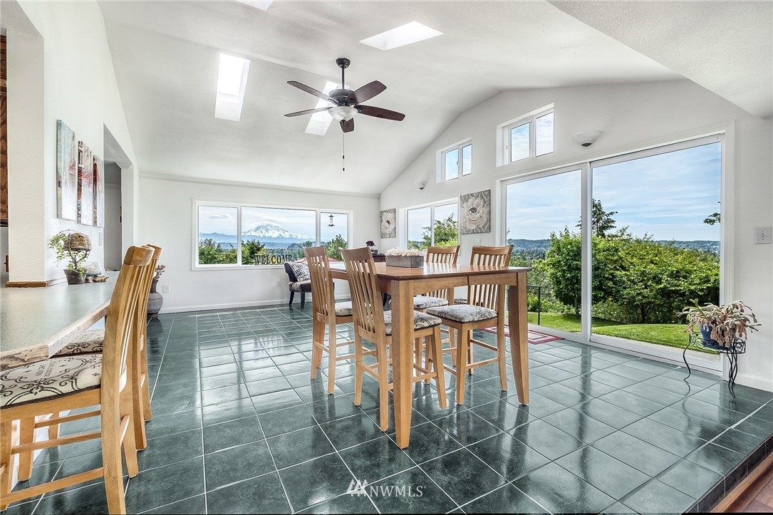 11112 Karshner Road East Edgewood, WA 98372 - Photo 7 of 40 a dining room with furniture and a floor to ceiling window