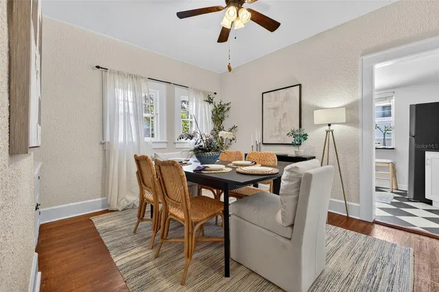 a view of a dining room with furniture and wooden floor