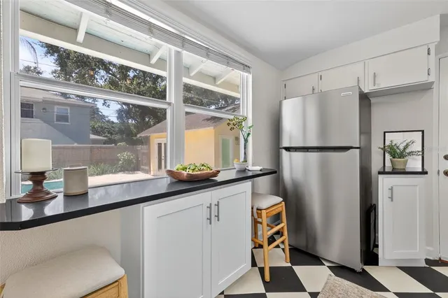 a kitchen with granite countertop a refrigerator and a sink