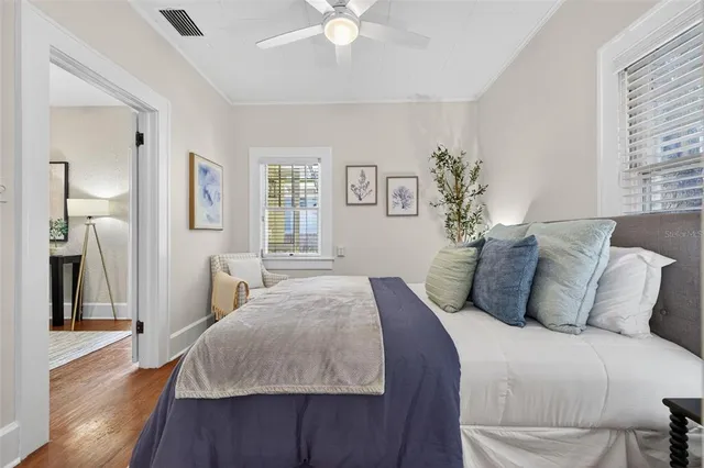a bedroom with a large bed and a chandelier