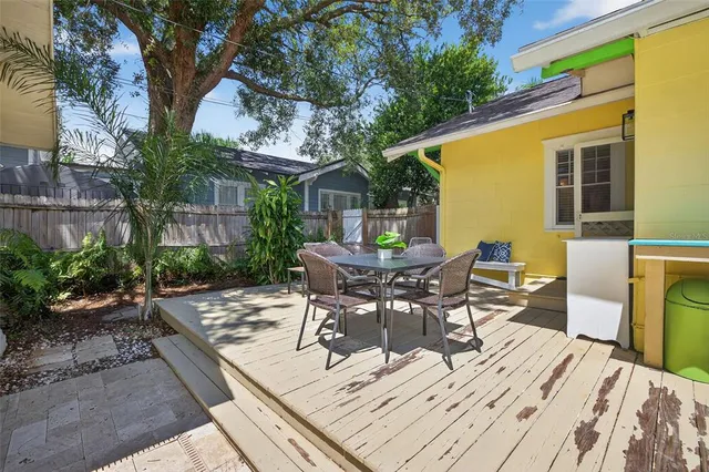 a view of a patio with table and chairs and potted plants