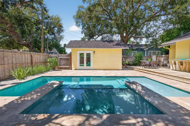 a view of backyard with swimming pool