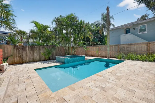 a view of backyard with swimming pool and outdoor seating