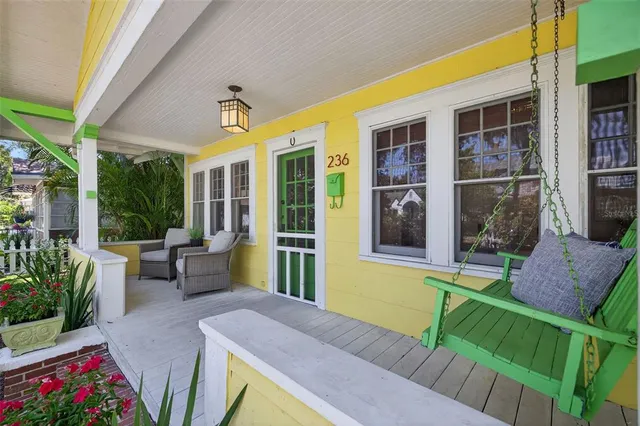 a front view of a house with outdoor seating and yard