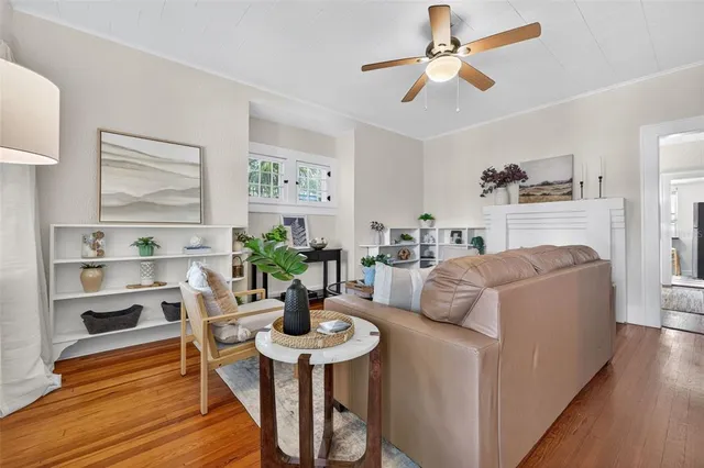 a living room with furniture and a wooden floor