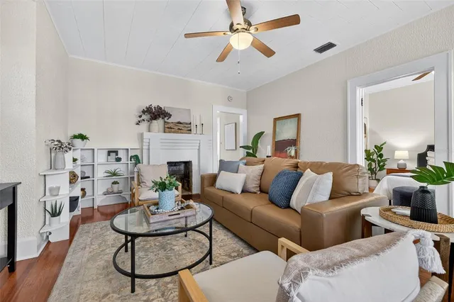 a living room with furniture a fireplace and a window