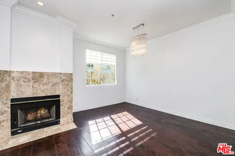 an empty room with windows and fireplace