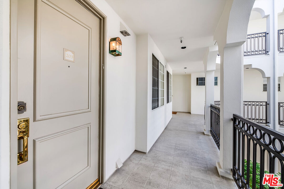 10630 Eastborne Avenue, Unit 203 Los Angeles, CA 90024 - Photo 4 of 26 a view of a hallway with wooden floor and staircase